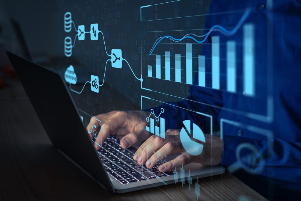 A pair of hands type on a laptop keyboard. Digital icons representing analytics and search engine optimization overlay the image.