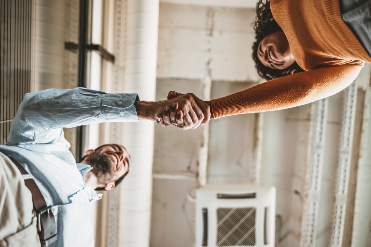 Two people shaking hands from an ant's eye view.