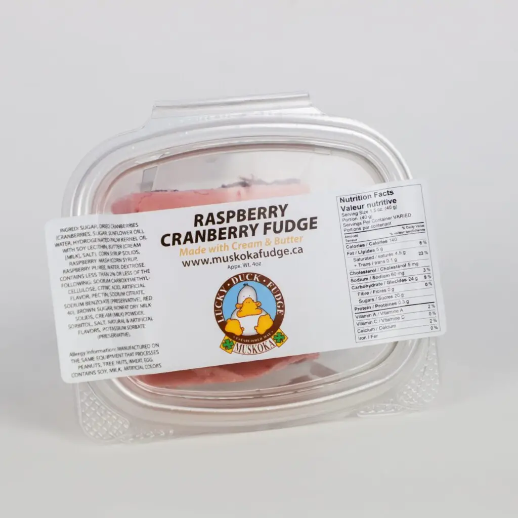 A plastic container of Lucky Duck Fudge's Raspberry Cranberry fudge flavour, photographed on a white background.